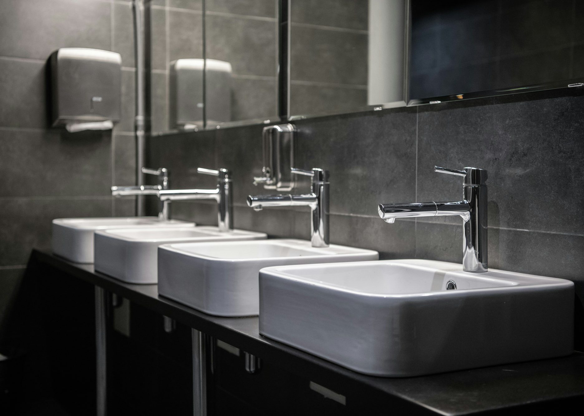 Interior of a modern public bathroom toilet in grey colors
